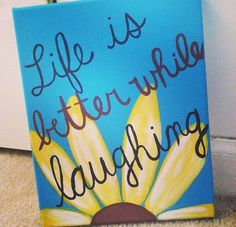 a painting that says life is better with laughing on it