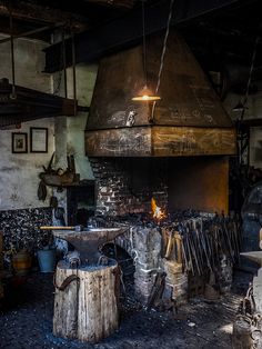 an old fashioned kitchen with wood burning in the fireplace