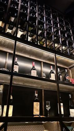 bottles of wine are lined up on shelves