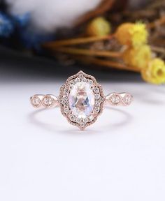 an oval shaped engagement ring with diamonds in the center