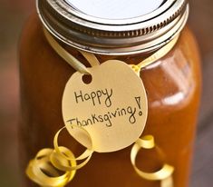 a mason jar with a happy thanksgiving tag on it