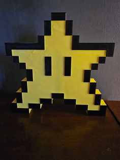 a yellow and black object sitting on top of a wooden table next to a wall