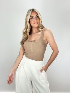 Introducing our Daylight Bodysuit - an elevated and chic essential for spring. Made from ribbed, soft, and stretchy material, with hidden snap closures and snap button details for a sleek and comfortable fit. Its thong design makes it perfect for layering, while its neutral and muted tones make it versatile for dinner or drinks. A must-have staple in any fashion-forward wardrobe. 73% Viscose 27% Nylon Hand wash cold separately. Summer Everyday Bodysuit, Solid Color Everyday Bodysuit For Spring, Chic Beige Bodysuit For Spring, Chic Bodysuit For Everyday Wear, Chic Solid Color Bodysuit For Everyday, Chic Ribbed Bodysuit For Loungewear, Chic Fitted Everyday Bodysuit, Chic Everyday Fitted Bodysuit, Chic Beige Bodysuit For Loungewear