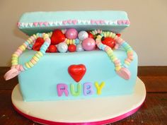 a cake that has been decorated to look like a car with candy in the trunk