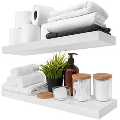 two white shelves with towels, soaps and other bathroom items on top of each shelf