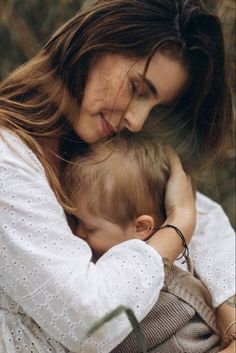 a woman holding a baby in her arms