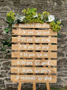 a wooden sign with white writing on it that says days of the day and flowers