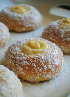 powdered sugar covered donuts on a white tray