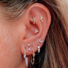 a close up of a person's ear with several different types of piercings