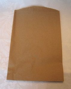 a brown paper bag sitting on top of a white table