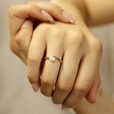 two hands holding each other while one holds the other's hand with a diamond ring on it