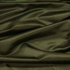 a close up view of a dark green satin fabric with very thin lines on it