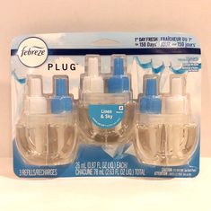 four clear and blue hand sanitizers in plastic packaging