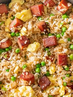 rice, peas and sausage are mixed together in a skillet