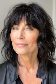 Save this pin for the best shag hairstyles for women over 50. This striking mid-length shag features wispy bangs that beautifully frame the face. The layered cut adds texture and movement, making it a fantastic choice for women with naturally wavy hair. Wavy Bob With Bangs Over 50, Curly Mid Length Hair With Bangs, Mid Wavy Hairstyles, Mid Length Shag Haircut With Bangs, Modern Shag Hairstyles, Haircut Ideas Brown Hair, Modern Shag, Medium Shag Haircuts, Shaggy Short Hair