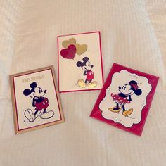 two greeting cards with mickey and minnie mouse on them, one has a balloon in the shape of a heart