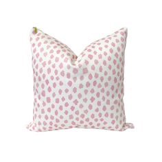 a pink and white pillow with hearts on it