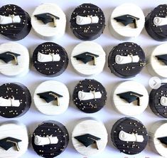 graduation cupcakes decorated with black and white icing, topped with gold accents