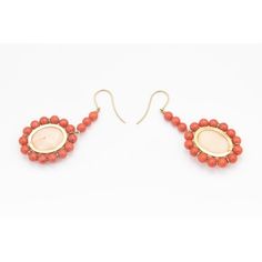 This is part of Chairish’s Fine Jewelry assortment.  These earrings feature a large oval cabochon angel skin coral piece measuring approximately  .80" x .60" set in a frame of orange coral beads measuring approximately 5.5 mm each.  The earrings dangle off an 18k yellow gold wire.  Pierced ears are required to wear these. Orange Dangle Pierced Jewelry, Elegant Coral Drop Earrings, Coral Earrings Dangle, Oval Coral Cabochon Jewelry, Coral Drop Earrings, Coral Beads, Gold Wire, Late 20th Century, Oval Cabochon