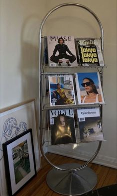 a metal magazine rack with magazines on it