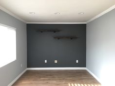 an empty room with two shelves on the wall