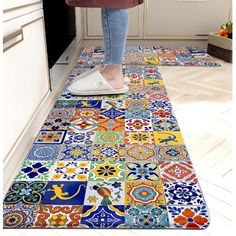 a woman is standing on the kitchen floor with her feet in the oven door mat