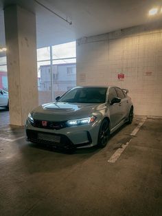 a car is parked in an empty parking garage