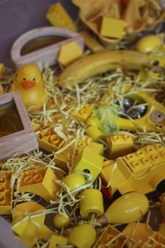 yellow legos and other toys in a plastic container