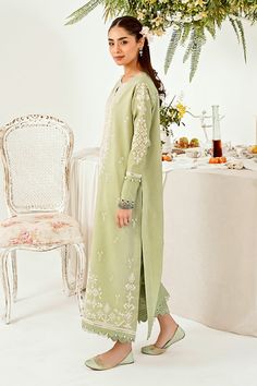 Introducing "Mint Majesty," a captivating ensemble in our summer collection. This pastel green outfit exudes a sense of freshness, adorned with intricate chikankari embroidery delicately tracing the neckline, hemline (daman), and sleeves. Paired with tailored trouser pants, it stands as a class apart, epitomizing effortless sophistication and timeless charm. Step into the realm of elegance with "Mint Majesty," where every detail speaks of refined grace and unmatched allure. Gul Ahmed, Green Outfit, Pastel Green, Trouser Pants, Product Label, Designer Suits, Summer Collection, Mint, Ready To Wear