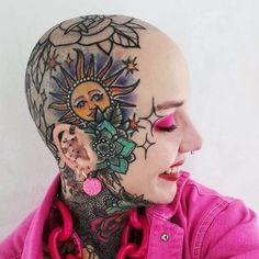 a woman with tattoos and piercings on her head