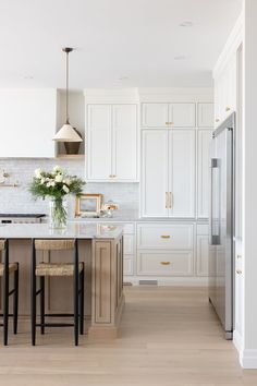 an image of a kitchen setting with white cabinets and marble counter tops on instagram