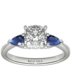 an engagement ring with three pear shaped blue sapphire stones