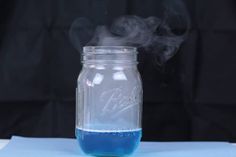 a jar filled with blue liquid sitting on top of a table