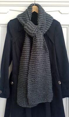 Extra long chunky unisex scarf in classic dark grey. Acrylic yarn is super soft and easy-wash. Perfect for the chilly winter ahead! Machine washable and dryable or dry clean. Do not bleach or iron. FREE EXTRAS AVAILABLE: Your choice of tassels, pom poms, or infinity scarf (ends joined for looped scarf) All proceeds go to Knitting for Nepal in collaboration with Architects Without Frontiers. Cozy Gray Scarf For Cold Weather, Cozy Gray Scarves For Cold Weather, Casual Gray Winter Scarf, Chunky Scarves, Grey Scarf, Knit Scarf, Pom Poms, Infinity Scarf, Chunky Knit