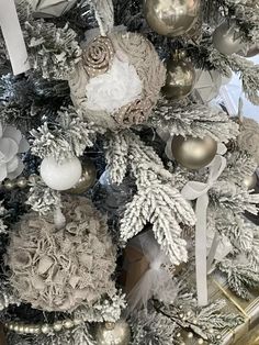 a christmas tree decorated with silver and white ornaments