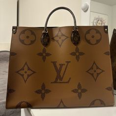 Louis Vuitton On The Go Tote MM Brown Monogram Reverse Leather Luxury Monogram Canvas Shoulder Bag, Luxury Monogram Canvas Tan Shoulder Bag, Luxury Tan Monogram Canvas Shoulder Bag, Luxury Leather Bag With Monogram Print, Luxury Leather Bags With Monogram Print, Luxury Bag With Monogram Print And Double Handle, Luxury Tan Bag In Signature Coated Canvas, Luxury Tan Bags In Signature Coated Canvas, Luxury Tan Signature Coated Canvas Bag