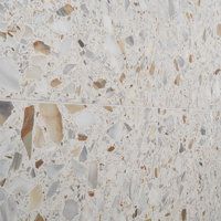 a white marble wall with brown and tan speckles