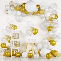 a white and gold baby shower with balloons