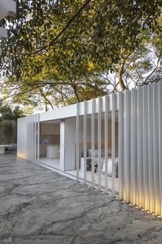 a white building with vertical slats on the outside