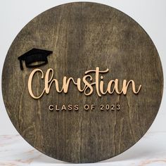 a wooden sign that says, christian class of 2013 with a graduation cap on it