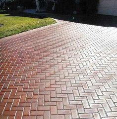 a fire hydrant sitting on the side of a brick road in front of a house