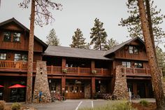 a large wooden building surrounded by tall trees