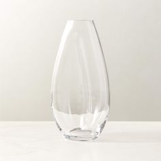 a clear vase sitting on top of a white table