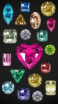 many different colored diamonds are arranged in the shape of a heart on a black background