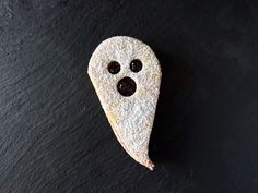 a piece of food that is shaped like a ghost with two eyes and one nose