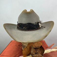 Western Style High Crown Hat Band For Winter, Adjustable Gray Hat For Rodeo, Western Style Wide Brim Gray Hat, Rustic High Crown Hat For Rodeo, Western High Crown Hat For Winter, Gray Western Hat With Short Brim, Curved Brim Felt Hat With Feathers For Ranch, Adjustable Gray Western Hat Band, Gray Western Fedora Hat