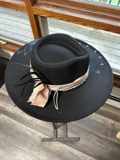 Discover the rugged charm of our Burned Western Hat. This unique, handcrafted cowboy hat features a distressed look, giving it a vintage, well-worn appeal perfect for Western enthusiasts and fashion-forward individuals. Features: Handcrafted Design: Each hat is meticulously burned and distressed to achieve a one-of-a-kind look. Premium Materials: Made from high-quality materials for durability and comfort. Unique Aesthetic: The burned finish adds a distinctive vintage style that sets it apart. B Black Bohemian Fedora For Country Events, Rustic Black Hat For Rodeo, Rustic Wide Brim Felt Hat For Kentucky Derby, Country Style Distressed Wide Brim Hats, Bohemian Distressed Adjustable Hat Bands, Black Bohemian Felt Hat For Kentucky Derby, Bohemian Black Hat Bands For Ranch, Black Rustic Adjustable Hat, Bohemian Distressed Fedora Hat