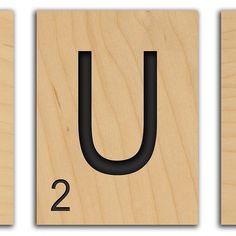 three wooden blocks with the letter u and number two