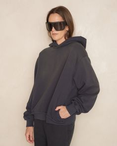 Hooded Stockholm sweater by Acne Studios in black. Unisex relaxed hoodie crafted from a fleece cotton blend, featuring sprayed finish for vintage effect. Minimal construction with dropped shoulders, side pockets and a cordless hood. Typically Acne weathered styling with the Stockholm stamp logo at the rear and distressed cuff and hem detailing. 89% Cotton, 11% Polyester.Made in Portugal. Pictured with Davis Temple Sunglasses by Rick Owens and Tabi Sneakers by Maison Margiela. Washed Black Hoodie Sweatshirt With Ribbed Cuffs, Oversized Washed Black Hoodie For Fall, Washed Black Long Sleeve Hoodie With Drawstring, Fall Athleisure Washed Hoodie, Washed Hooded Hoodie For Athleisure, Washed Athleisure Hooded Hoodie, Washed Athleisure Hoodie, Winter Washed Black Sweatshirt With Drawstring Hood, Winter Sweatshirt With Drawstring Hood In Washed Black