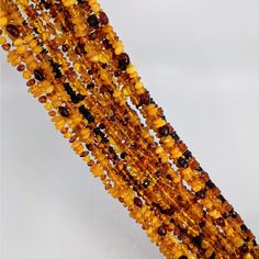 Close-up of colorful beads in Amber Beaded 30’ Long Necklace #LV4677, vibrant long necklace Spiritual Amber Beaded Necklaces With Natural Stones, Spiritual Hand-strung Amber Beaded Necklaces, Spiritual Amber Beaded Necklace With Natural Stones, Amber Crystal Necklace With Natural Stones For Healing, Amber Citrine Beaded Necklace, Amber Beaded Necklace As A Gift, Amber Necklace With Faceted Oval Beads, Spiritual Amber Crystal Necklaces With Round Beads, Spiritual Amber Necklace